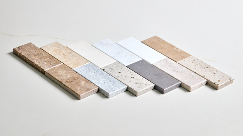 Small samples of different countertop materials laid out for review