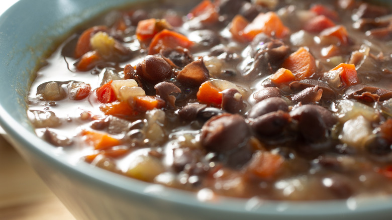 A close-up image of a bowl of hearty homemade bean soup