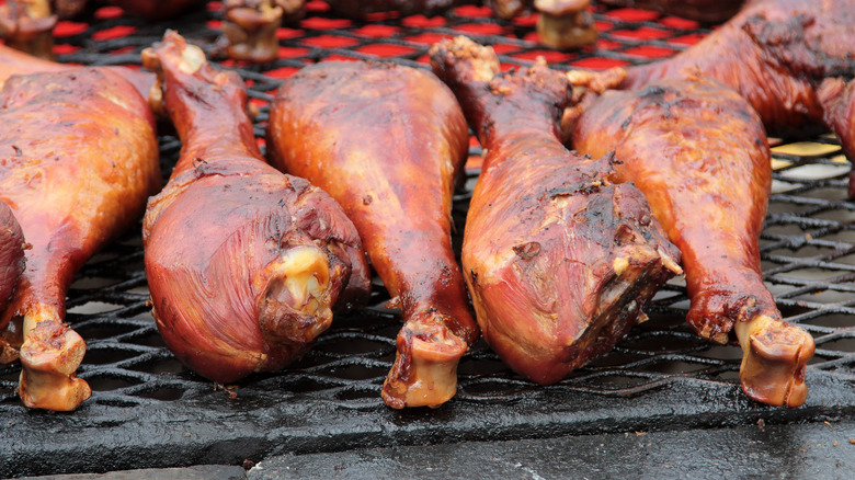 A close-up image of smoked turkey legs on a grill
