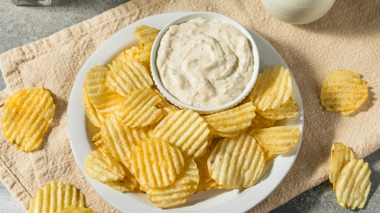 Plain ruffle chips and a bowl of French onion dip