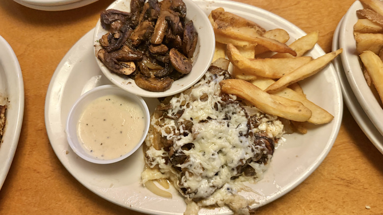 Smothered chicken meal on a white plate
