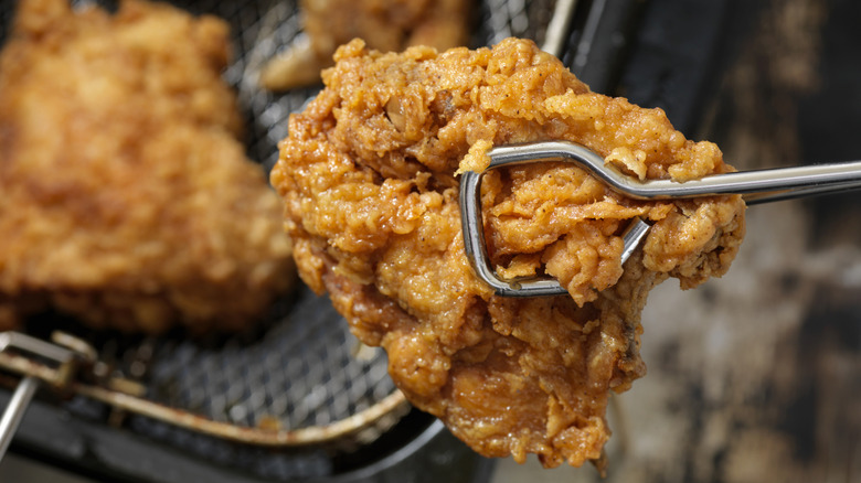Closeup of fried chicken in frying basket