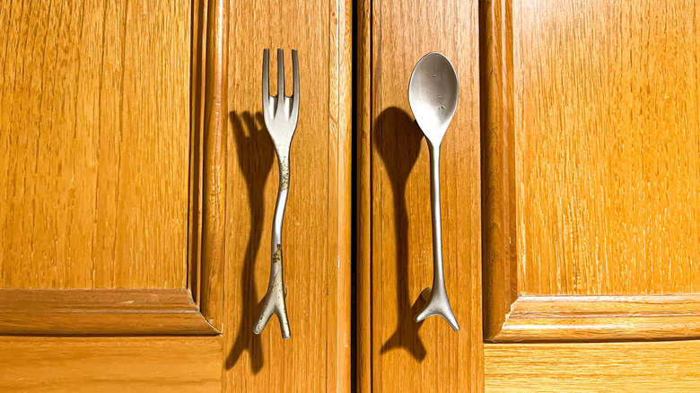 Fork and spoon handles on oak cabinets