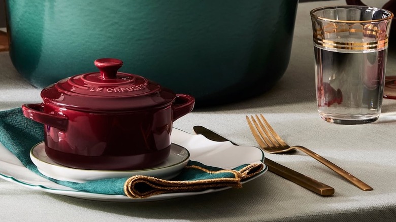 Le Creuset dishware with silverware beside
