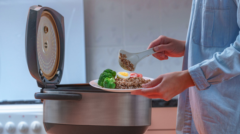 Person serving food out of slow cooker