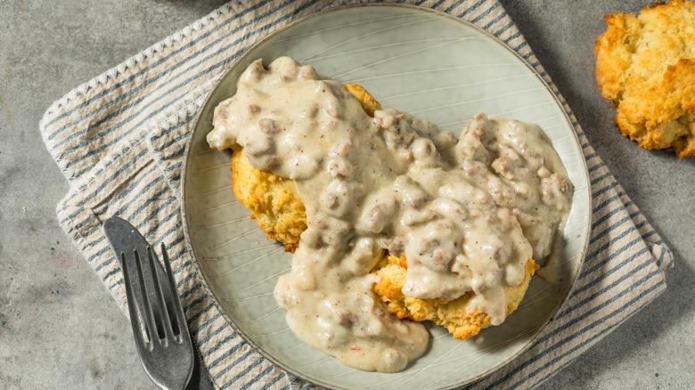 Sausage gravy and biscuits on plate 
