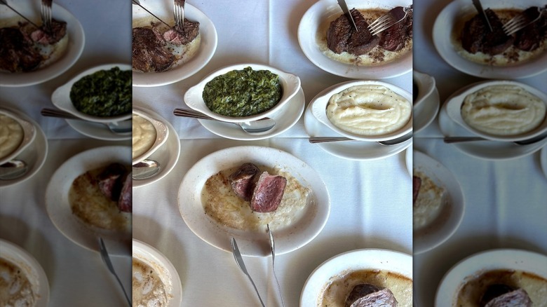 Several plates of steak and sides at Ruth's Chris Steakhouse