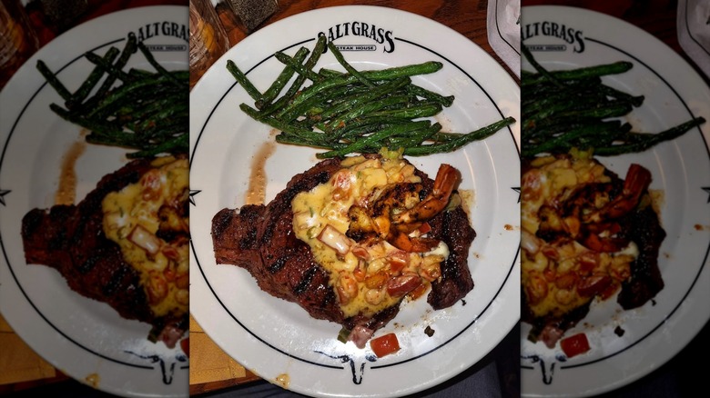 A smothered steak and green beans at Saltgrass