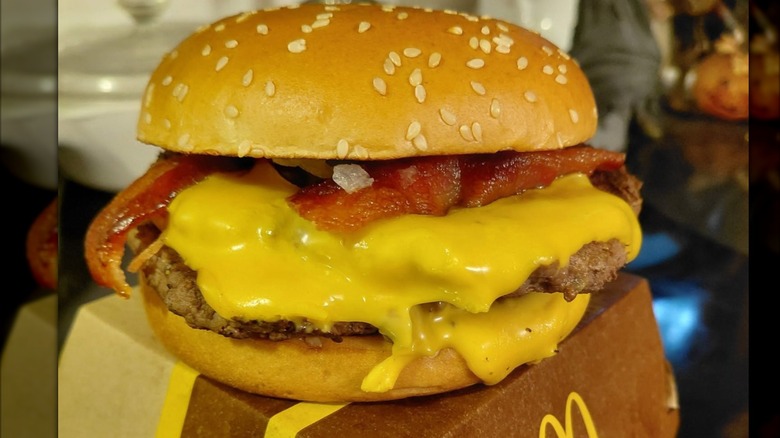A McDonald's Double Bacon Quarter Pounder sitting on top of its box