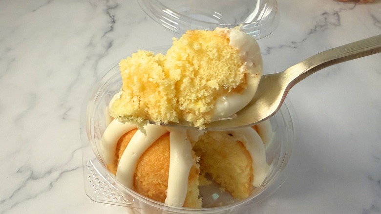 Nothing Bundt Cakes Lemon cake piece on fork above bundtlet