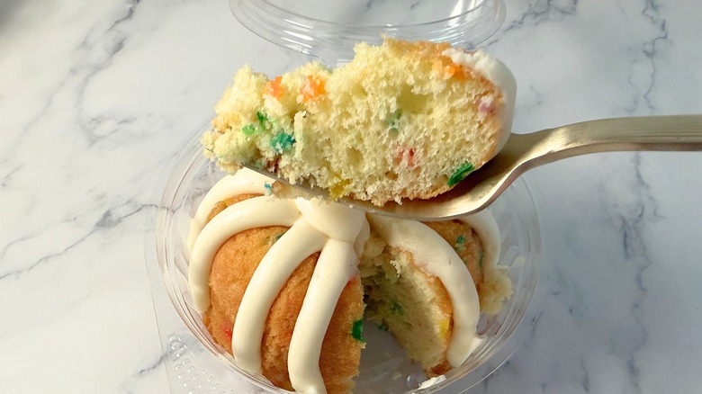 Nothing Bundt Cakes Confetti cake piece on fork above bundtlet