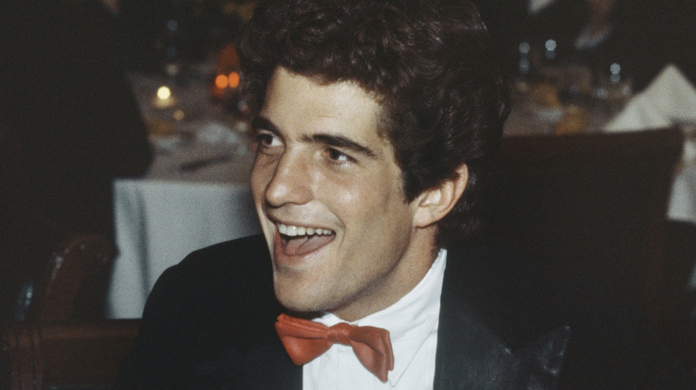 JFK Jr. in formal wear smiling at event