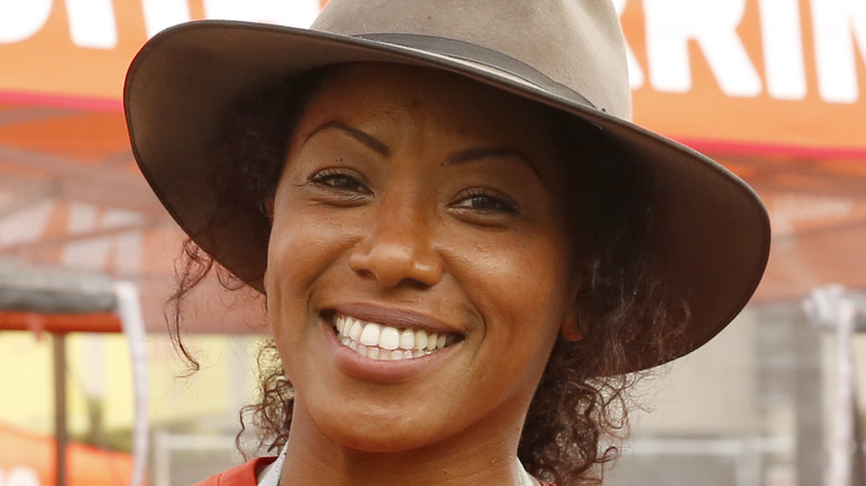 Nyesha Arrington smiling in cowboy hat