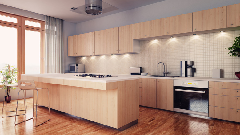 a modern kitchen with oak cabinets