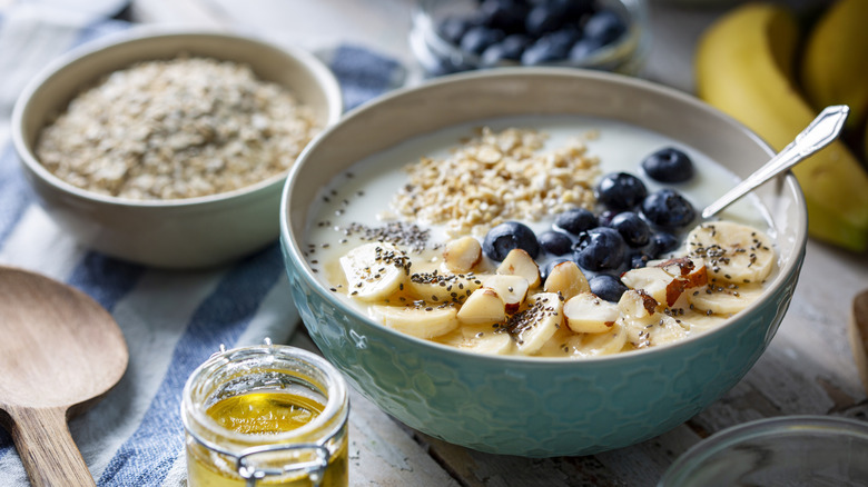 Bowl of oatmeal with fruit and honey