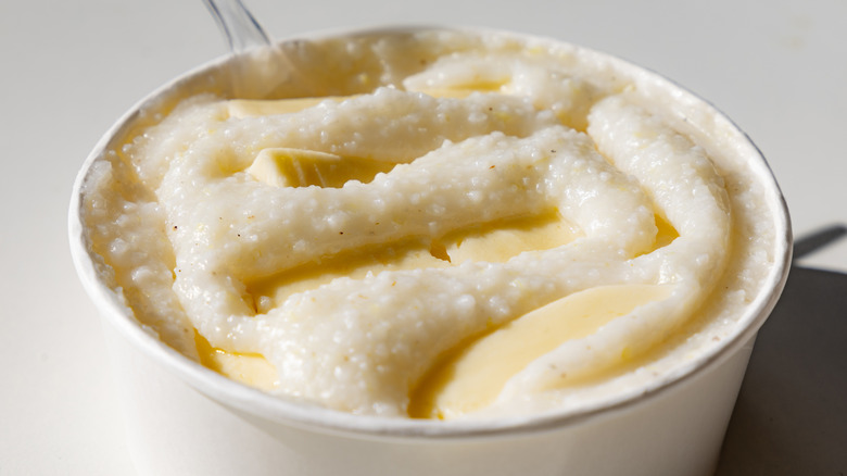 Close-up of grits porridge with chunks of butter on top