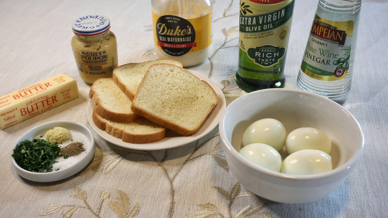 egg toast ingredients arrayed on a table with a white tablecloth