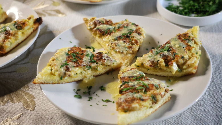 four egg toasts artfully arranged on a small plate