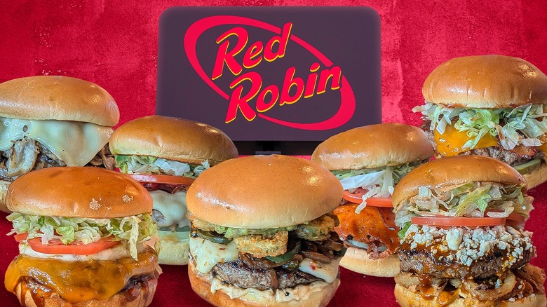 Several Red Robin burgers underneath the chain's signage, against a red background