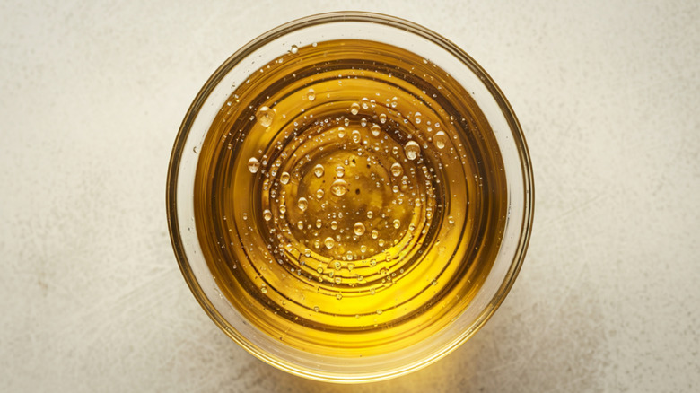 Top of a small glass bowl filled with oil