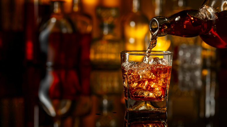 Whiskey being poured into a rocks glass