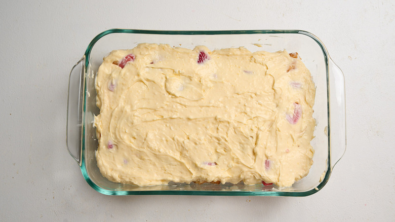 spreading pudding mixture into casserole dish