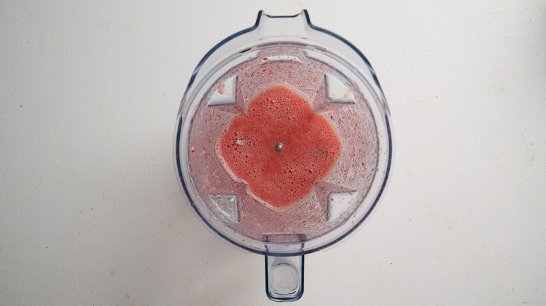 Blended strawberries in a blender