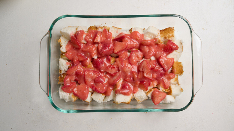 spreading strawberry filling on top of angel food cake