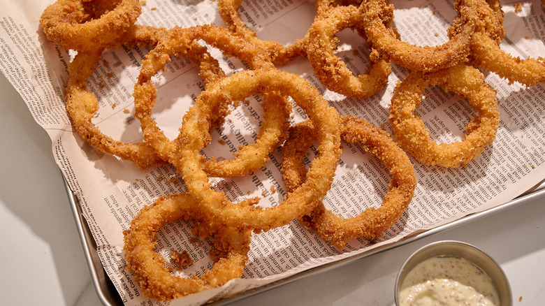 Onion rings piled onto a platter