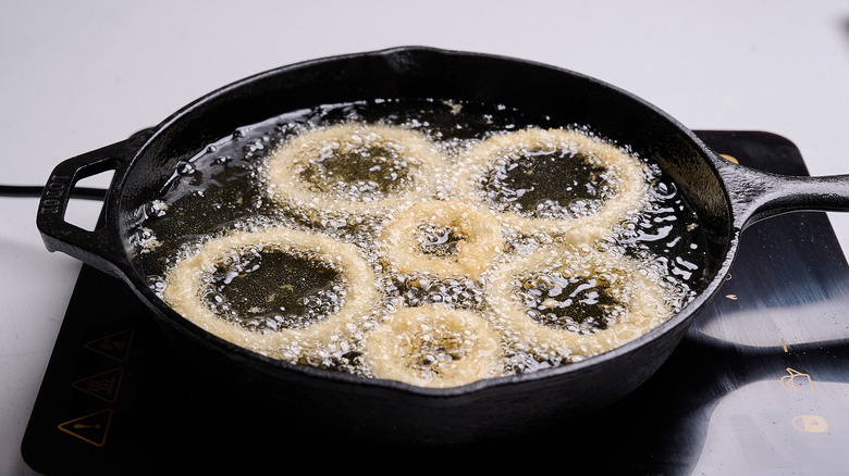 adding onions to hot oil