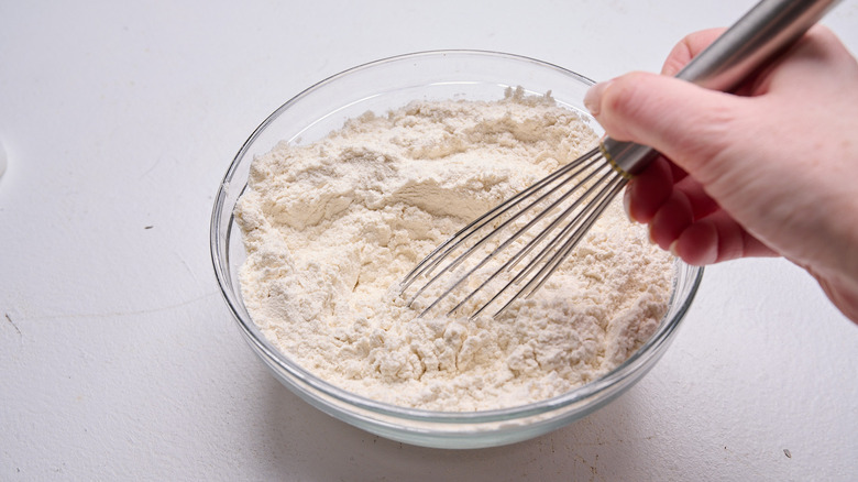 mixing flour and baking powder in a bowl