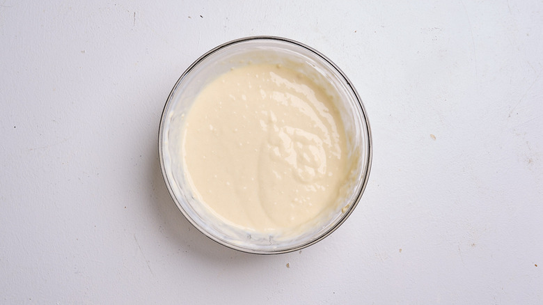 mixing flour and buttermilk in a bowl