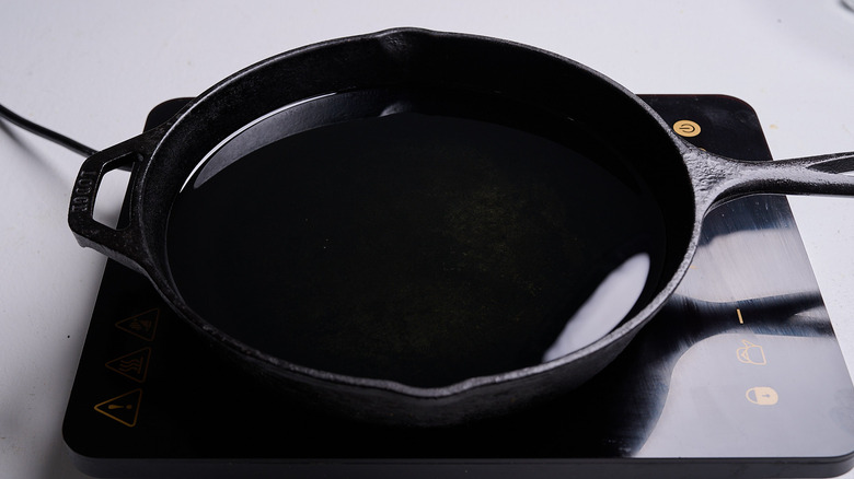 heating oil in a cast iron skillet