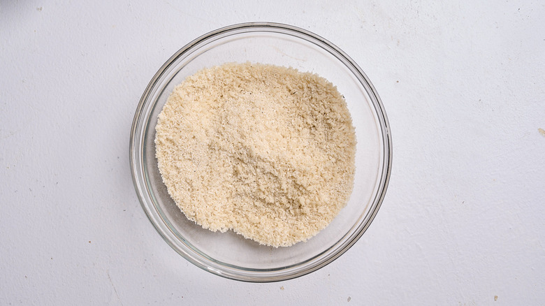 combining breadcrumbs with seasoning in bowl