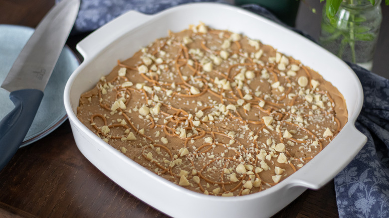 Old-fashioned peanut butter fudge in a tray with a knife on the side