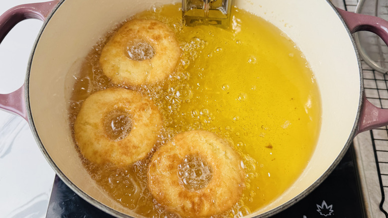 Old-fashioned doughnuts frying in oil