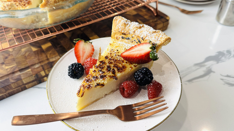Slice of sugar cream pie on a plate with berries