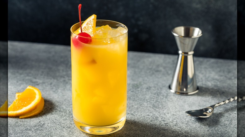 orange harvey wallbanger cocktail with cherry and orange garnish