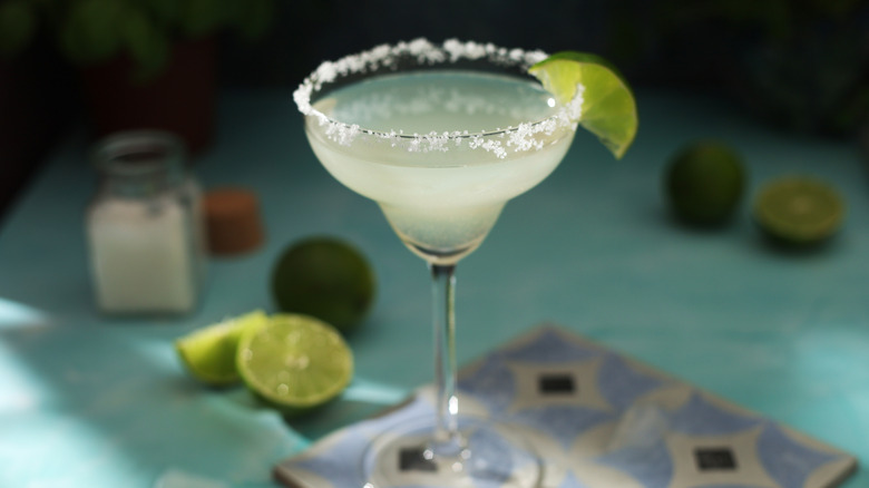 margarita cocktail in classic glass with salt rim and lime