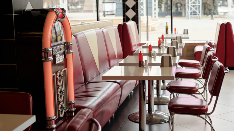 vintage looking diner with jukebox, chairs and booths