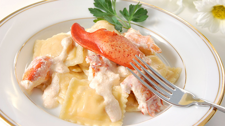 lobster ravioli topped with a lobster claw