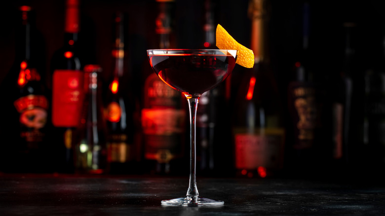 an Adonis cocktail on a dark bar