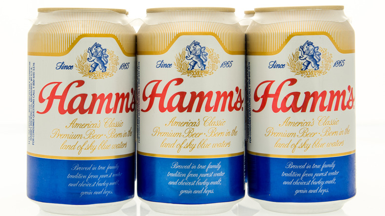 Row of Hamm's beer cans on a white background