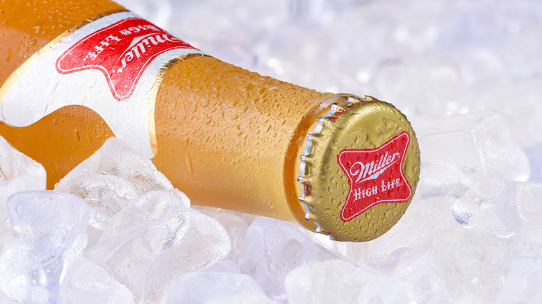 Close-up of a Miller High Life bottle on ice