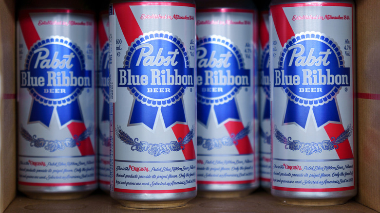 Cans of beer inside of a box of Pabst Blue Ribbon