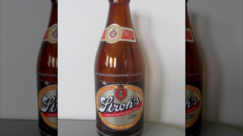 Mirrored image of a Stroh's beer bottle against a white wall