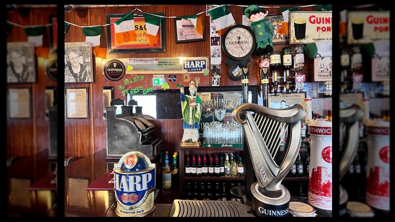 Bar with clocks, decorations, and beer signs on the wall at Morahans Bar