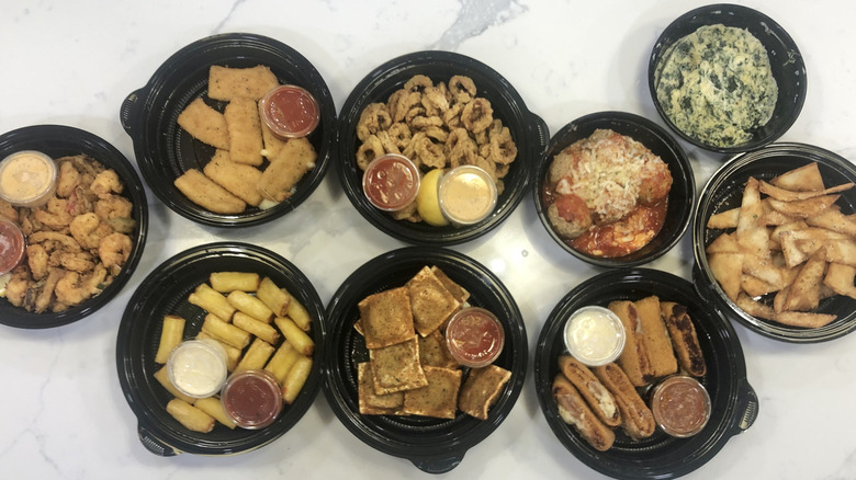 8 different Olive Garden appetizers in to-go containers.