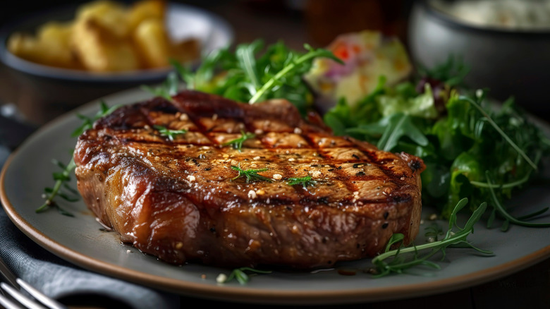 Succulent Grilled Ribeye Steak with Rich Potato Gratin and Garden-Fresh Salad