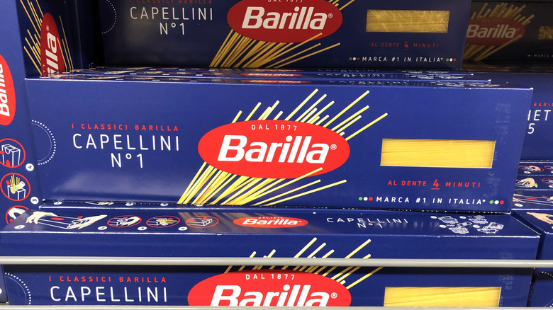 Packets of Barilla pasta on a store shelf